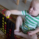 Baby playing connect 4